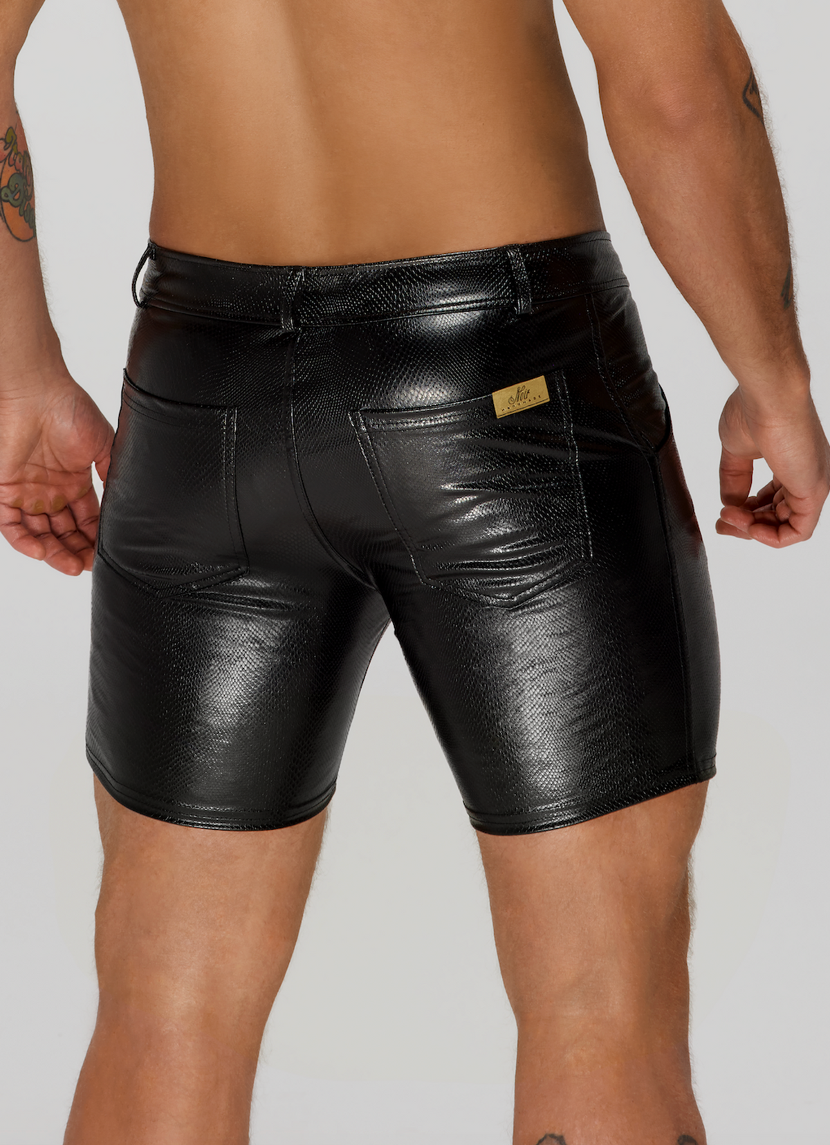 Men’s black snake-pattern wetlook shorts, rear pocket detail.