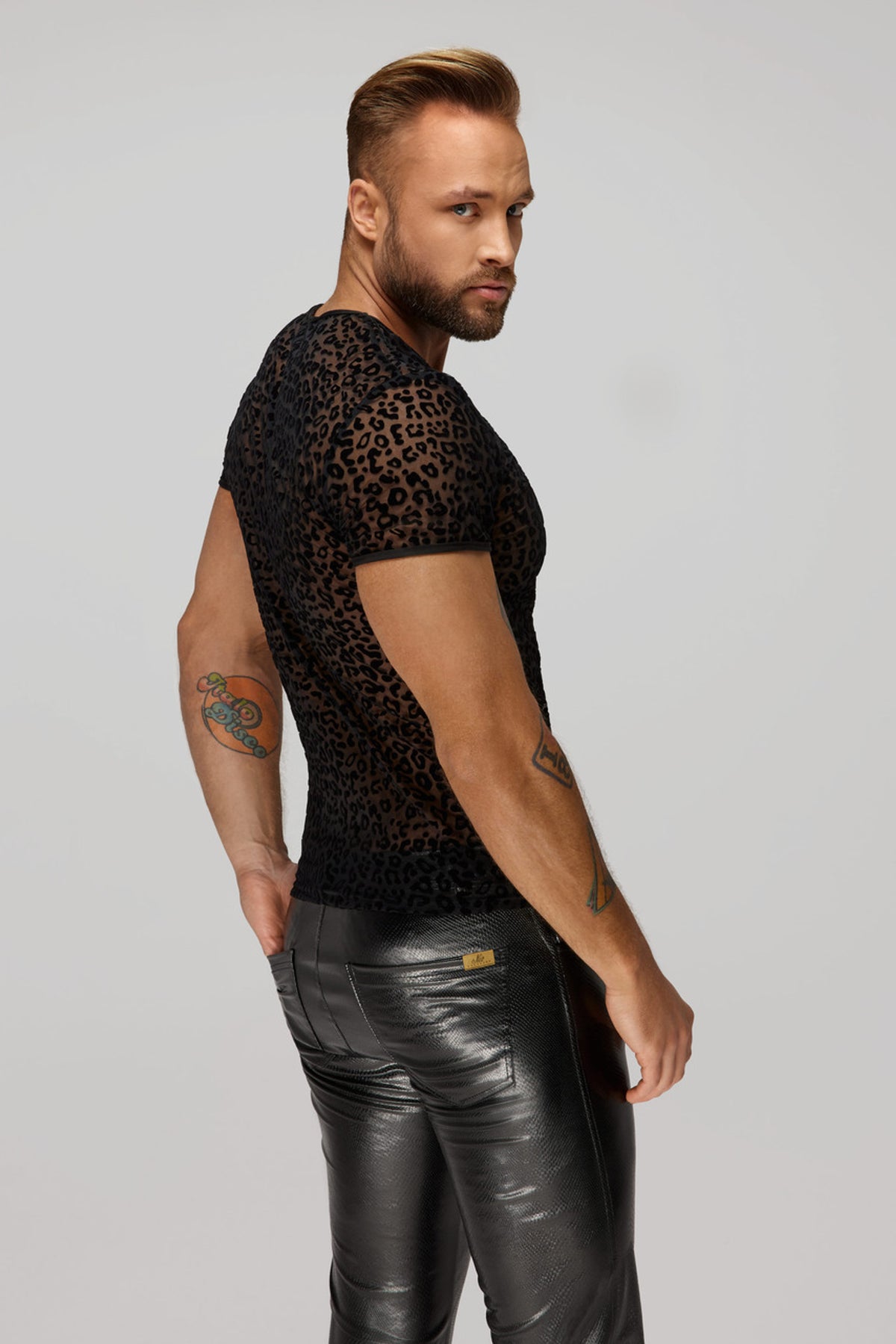 Men’s black leopard flock V-neck T-shirt, rear three-quarter view.