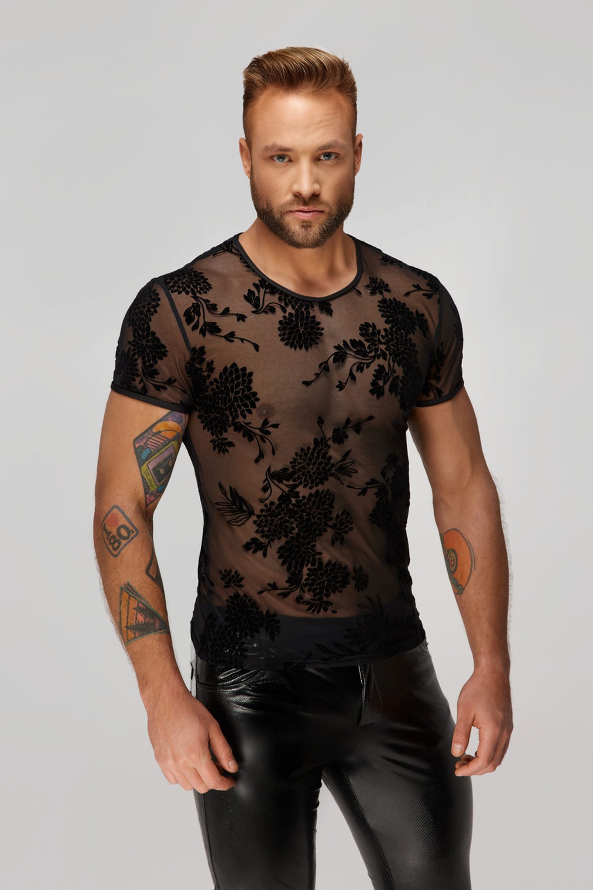 Men’s black sheer T-shirt with floral flock pattern, front view.